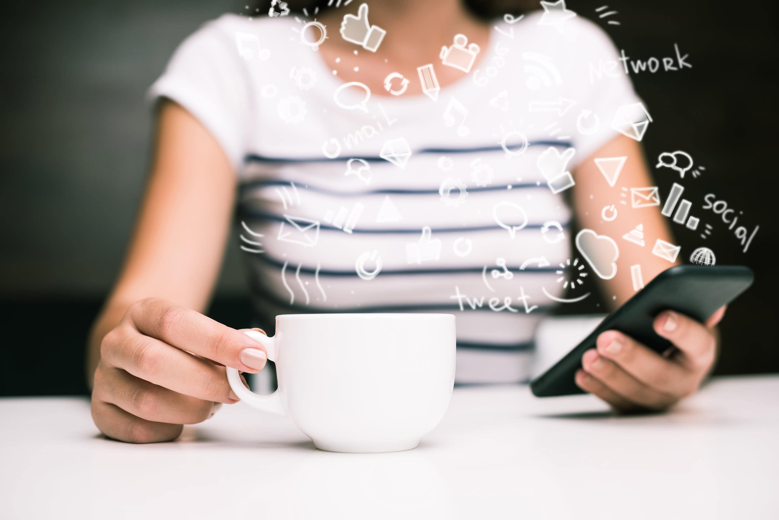 Abstract image of woman holding coffee cup and browsing social media.