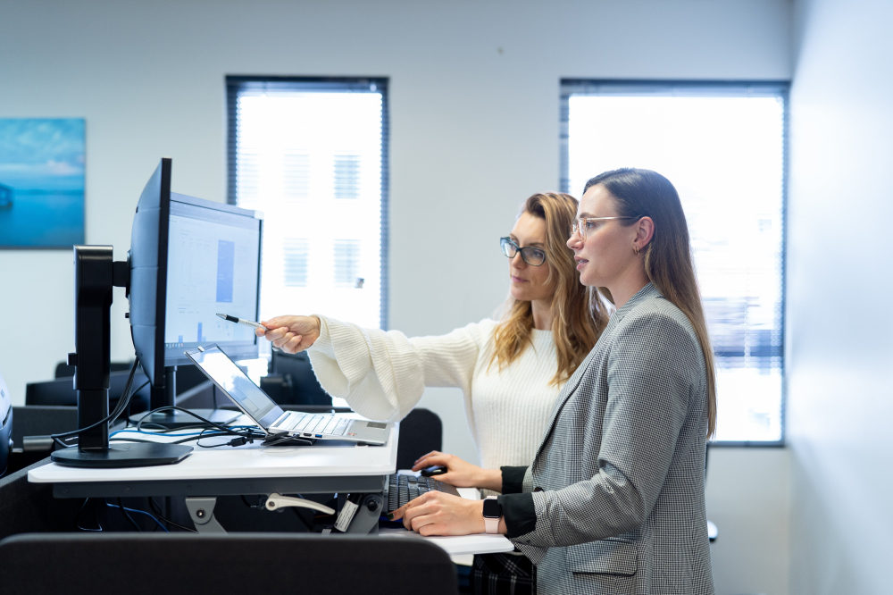 Two staff member at stand up desk