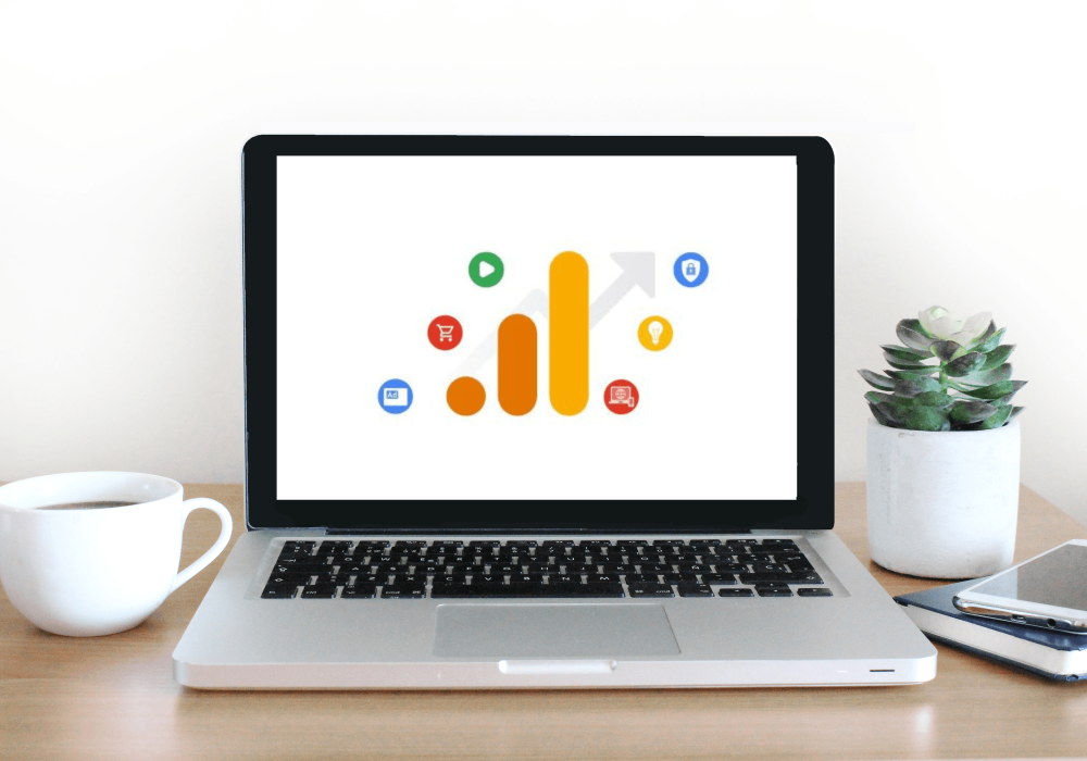 Laptop screen with Google Analytics 4 logo displayed.