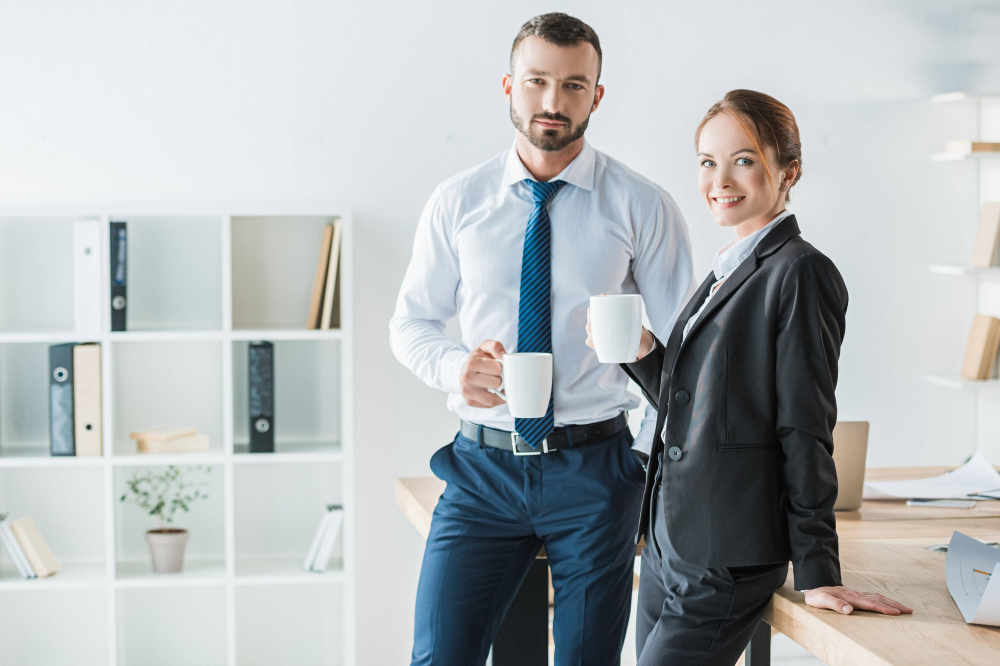 Professional accountants standing in office smiling.