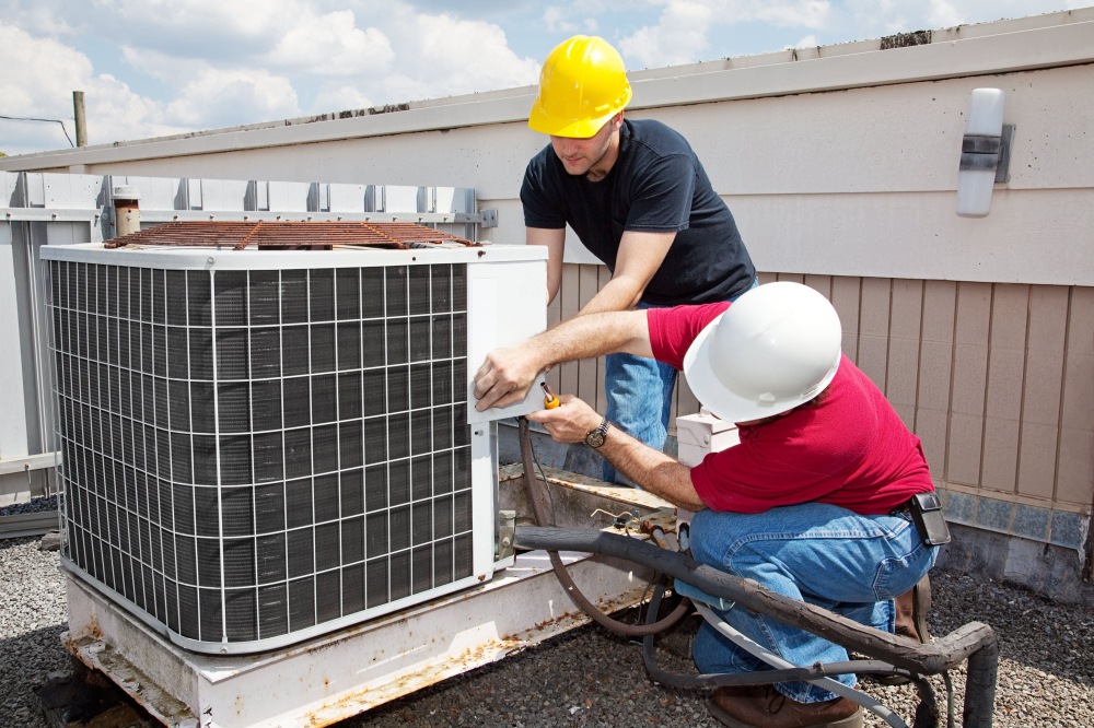 Professional technicians installing hvac airconditioning unit.