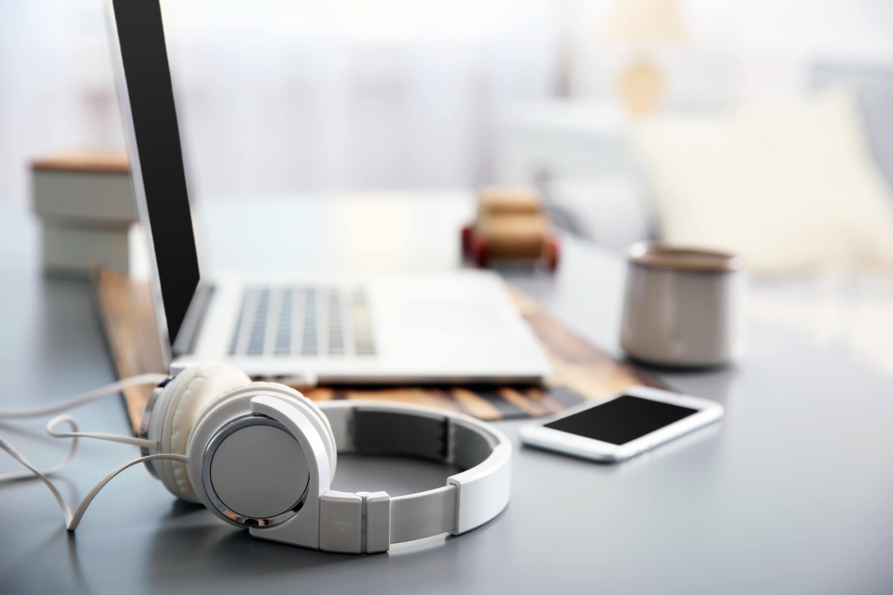 Laptop and headphones setup to record call tracking.